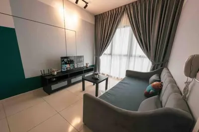 a living room with a couch and a television at Continew Residence Cozy Suite by GUESTONIC in Kuala Lumpur
