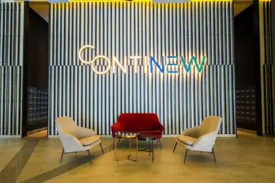 a lobby with three chairs and a red couch at Continew Residence Cozy Suite by GUESTONIC in Kuala Lumpur