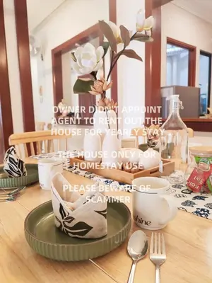 a table with a plate with a vase of flowers on it at KLCC Night View Spacious Muji MITEC 3min 121CAE in Kuala Lumpur