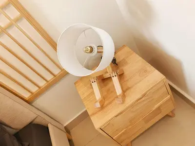 a mirror on top of a wooden table with a chair at KLCC Night View Spacious Muji MITEC 3min 121CAE in Kuala Lumpur