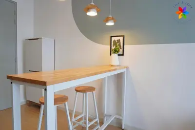 a kitchen with a table and two stools at The Pano @ Jalan Ipoh by Lily and Loft in Kuala Lumpur