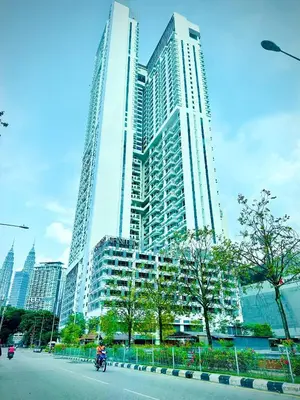 a large tall building in front of a city at The Colony Stay Well studio with KL View in Kuala Lumpur