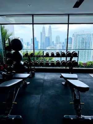 a gym with chairs and a view of the city at The Colony Stay Well studio with KL View in Kuala Lumpur