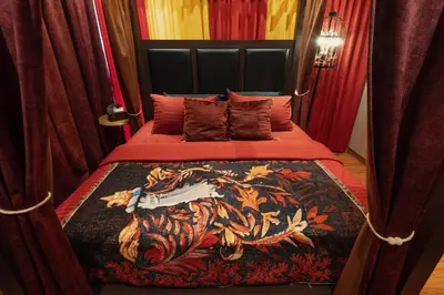 a bedroom with a bed with a painting on it at Wizarding Residence near KLCC link LRT & Mall in Kuala Lumpur