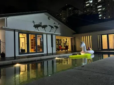 a house with a swimming pool in front of a house at Bungalow with Pool Karaoke PJ 12 in Petaling Jaya
