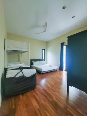 a large room with two beds and a wooden floor at Bungalow with Pool Karaoke PJ 12 in Petaling Jaya