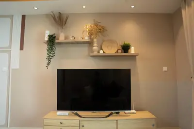 a living room with a large flat screen tv at OOAK SUITES AT MONT KIARA KUALA LUMPUR in Kuala Lumpur