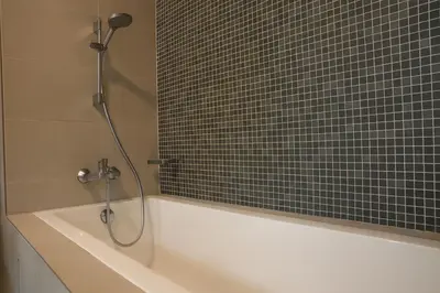 a bathroom with a bath tub with a shower at OOAK SUITES AT MONT KIARA KUALA LUMPUR in Kuala Lumpur