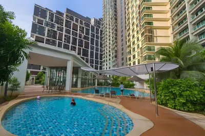a swimming pool in a building with tall buildings at OOAK SUITES AT MONT KIARA KUALA LUMPUR in Kuala Lumpur