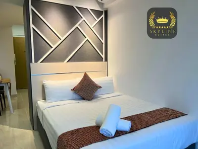 a bedroom with a bed with a blue object on it at The Colony Skyline Suites KLCC in Kuala Lumpur