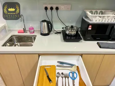a kitchen counter with a sink and a cutting board in a drawer at The Colony Skyline Suites KLCC in Kuala Lumpur