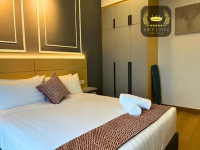 a bedroom with a bed with two towels on it at The Colony Skyline Suites KLCC in Kuala Lumpur
