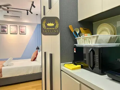 a kitchen with a microwave on a counter next to a bed at The Colony Skyline Suites KLCC in Kuala Lumpur