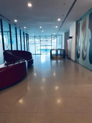 an empty room with a couch and a table in a building at Mercu Summer Suites KLCC by GRIHOZ Homestay in Kuala Lumpur