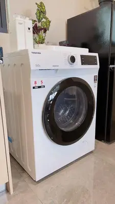 a white washing machine sitting in a room at TheOoak suite 4pax cozy home stay @mont kiara in Kuala Lumpur