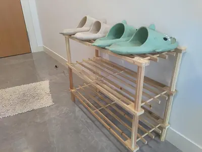 a couple of wooden shelves with shoes on them at TheOoak suite 4pax cozy home stay @mont kiara in Kuala Lumpur