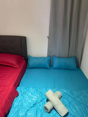 a bed with two towels on top of it at 100Mbps DesaPark MontKiara Publika Mitec Kepong Menjalara Segambut 7Pax in Kuala Lumpur