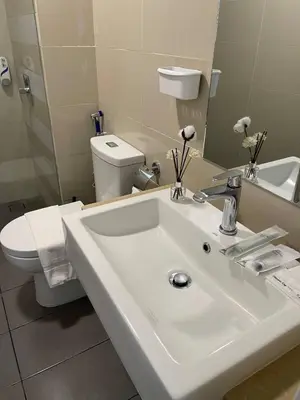 a bathroom with a white sink and a toilet at 100Mbps DesaPark MontKiara Publika Mitec Kepong Menjalara Segambut 7Pax in Kuala Lumpur