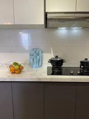 a kitchen counter with a bowl of fruit and a stove at 100Mbps DesaPark MontKiara Publika Mitec Kepong Menjalara Segambut 7Pax in Kuala Lumpur