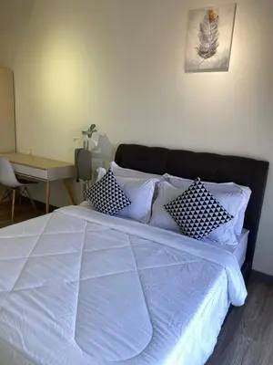 a bedroom with a white bed with pillows and a desk at 100Mbps DesaPark MontKiara Publika Mitec Kepong Menjalara Segambut 7Pax in Kuala Lumpur