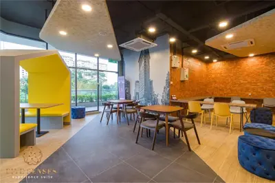 a restaurant with tables and chairs in a room at Neu Suites Residence Kuala Lumpur, Roam in Kuala Lumpur