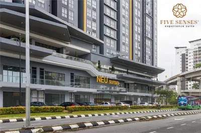 a new sites building with cars parked in front of it at Neu Suites Residence Kuala Lumpur, Roam in Kuala Lumpur