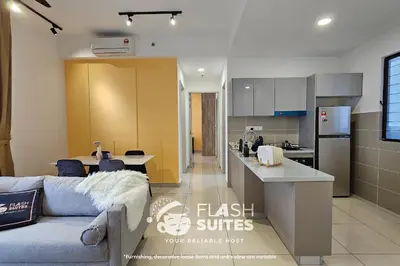 a living room with a couch and a kitchen at Trion Premium Suites @ KL in Kuala Lumpur