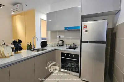 a kitchen with a stainless steel refrigerator and a sink at Trion Premium Suites @ KL in Kuala Lumpur