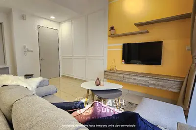 a living room with a couch and a tv at Trion Premium Suites @ KL in Kuala Lumpur
