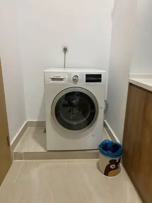 a washing machine in the corner of a room at Relax Bedroom Studio, The Luxe in Kuala Lumpur