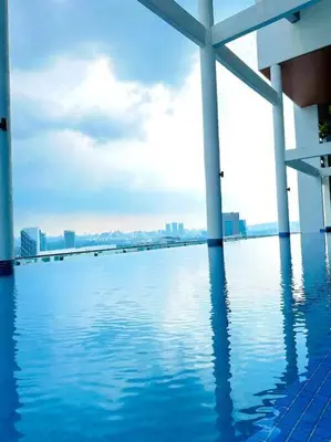 a large pool of water with a city in the background at Relax Bedroom Studio, The Luxe in Kuala Lumpur