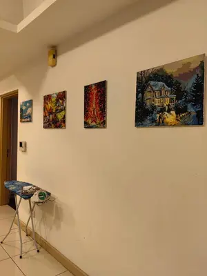 a room with four paintings on a wall at 5 Bukit Bintang 5 minutes to Alor Street Bukit Ceylon KLCC Pavilion Apt 3R2B 10 pax in Kuala Lumpur
