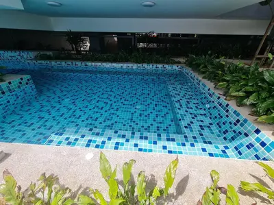a large swimming pool with blue tiles on it at 2R2B Apartment 10 mins to KLCC in Kuala Lumpur