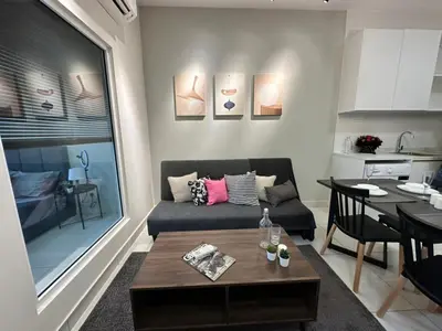 a living room with a couch and a table at Arte Mont Kiara Pool View in Kuala Lumpur