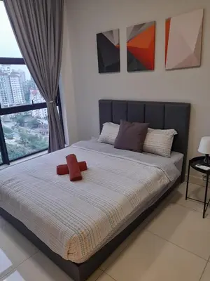 a bed with a red stuffed animal on top of it at Arte Mont Kiara Pool View in Kuala Lumpur