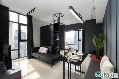 a living room with a black couch and a table at Axon Bukit Bintang Pavillion KL KLCC by GoMain in Kuala Lumpur