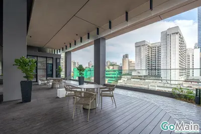a balcony with tables and chairs and a view of the city at Axon Bukit Bintang Pavillion KL KLCC by GoMain in Kuala Lumpur