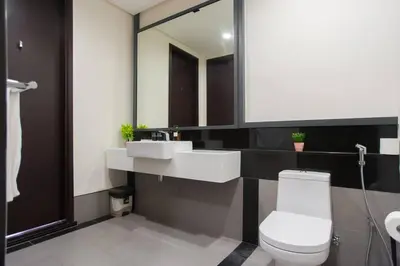 a bathroom with two sinks and a toilet and a mirror at TTs HOME3 Mews 4-8Pax Pavilion KLCC Kuala Lumpur in Kuala Lumpur