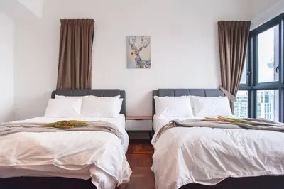two beds sitting next to each other in a bedroom at TTs HOME3 Mews 4-8Pax Pavilion KLCC Kuala Lumpur in Kuala Lumpur