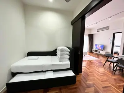 a bedroom with a bed and a living room at TTs HOME3 Mews 4-8Pax Pavilion KLCC Kuala Lumpur in Kuala Lumpur