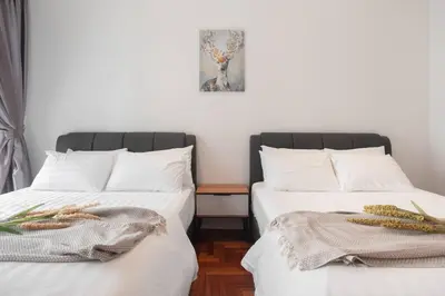 two beds sitting next to each other in a room at TTs HOME3 Mews 4-8Pax Pavilion KLCC Kuala Lumpur in Kuala Lumpur