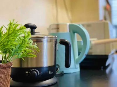 a tea pot sitting on a counter next to a cup at 3BR 8PAX KL City Centre KLCC View Ampang Boulevard Condo in Ampang