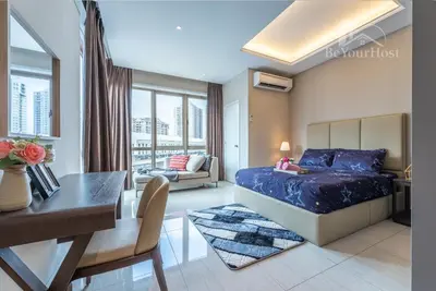 a bedroom with a bed and a desk and a dining room at Dorsett Residences Sri Hartamas (Kuala Lumpur) in Kuala Lumpur