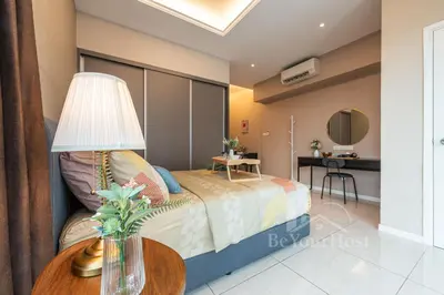 a bedroom with a bed and a table with a lamp at Dorsett Residences Sri Hartamas (Kuala Lumpur) in Kuala Lumpur