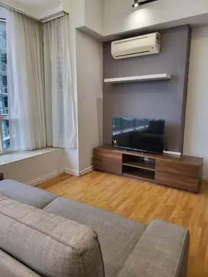 a living room with a flat screen tv and a couch at Park View KLCC ,by DeLive Home in Kuala Lumpur
