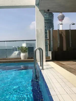 a swimming pool on the roof of a building at Park View KLCC ,by DeLive Home in Kuala Lumpur