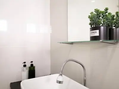 a white kitchen with a sink and a shelf with plants at The 29 Bungalow Setapak KL by Manhattan Group in Kuala Lumpur
