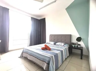 a bedroom with a bed with two orange pillows on it at MhPlatinum Gombak ShareHouse Room in Kuala Lumpur