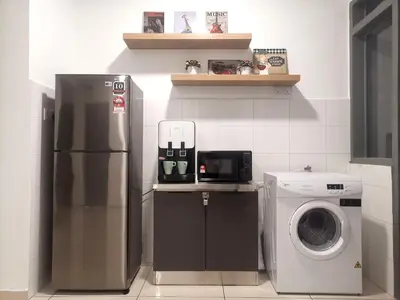a kitchen with a refrigerator and a washing machine at MhPlatinum Gombak ShareHouse Room in Kuala Lumpur