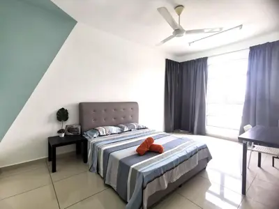 a bedroom with a bed with two orange pillows on it at MhPlatinum Gombak ShareHouse Room in Kuala Lumpur